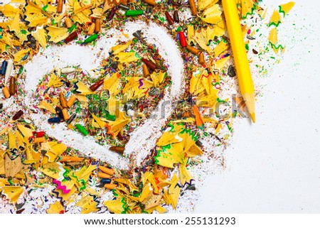 heart, yellow colored pencil and wood shavings