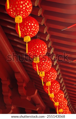 row of chinese paper lantern hanging from the roof