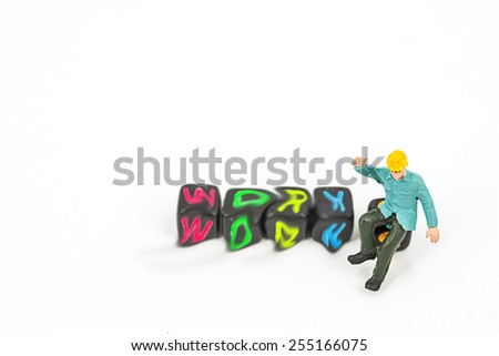 selective focus photo of miniature worker in blue suit standing on plastic toy on white background, abstract background to team work ,team building concept.