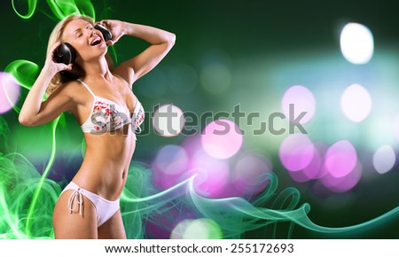 Attractive girl in white bikini and headphones on color background