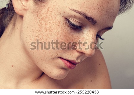 Young beautiful freckles woman face portrait with healthy skin Royalty-Free Stock Photo #255220438