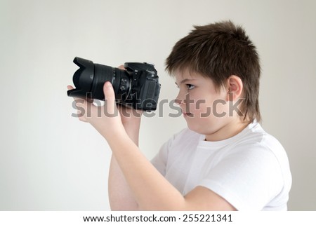 A teenage boy with camera on light