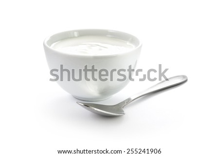 Hand-made yogurt in a bowl with spoon isolated on white background Royalty-Free Stock Photo #255241906