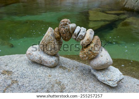 arch of granite stones on a background of water