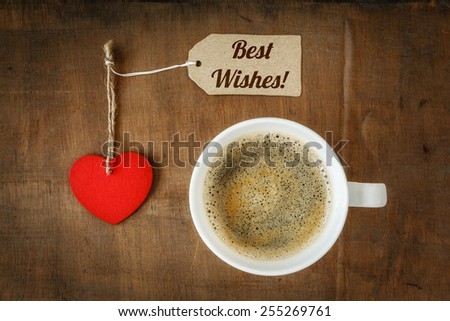 Coffee cup and heart on dark wood, Best wishes