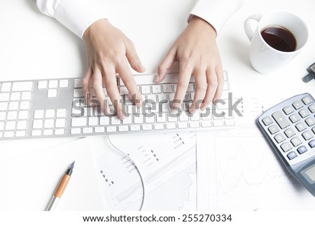 Woman working at desk, keyboard
