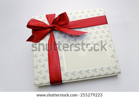 Printed over a red ribbon gift box