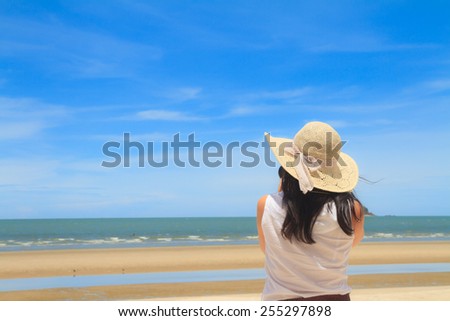 Woman using camera taking photos on the beach