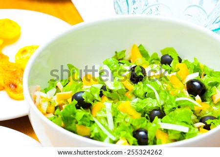 Assorted green leaf lettuce with squid and black olives