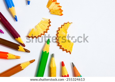 set of vintage colored pencils with chips on white background