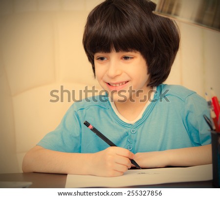 smiling child doing homework with computer, portrait. instagram image retro style