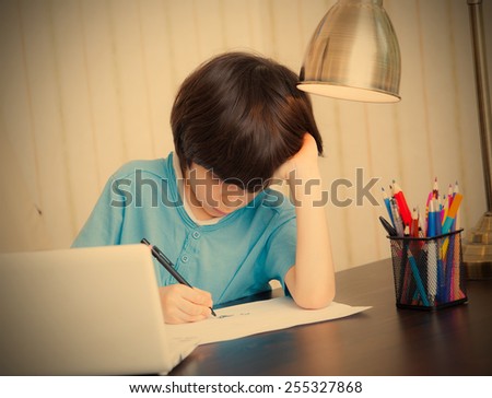 schoolboy doing homework, portrait. instagram image style