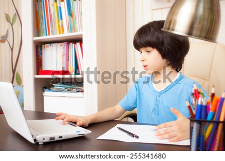 schoolboy doing homework on notebook, portrait
