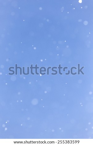 snowing on a blue sky