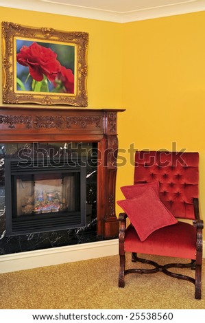 Fireplace and red chair, image on the wall is my own