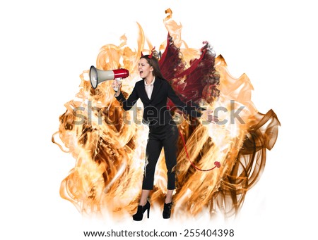 Girl in devil costume is shouting in megaphone from fire on white background