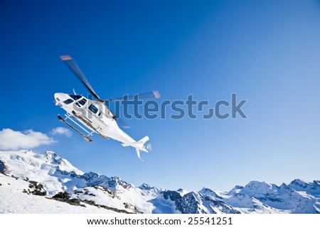 Heli Skiing Helicopter is landing on a ski slope in Gressoney Ski Resort, Aosta, Italy. Royalty-Free Stock Photo #25541251