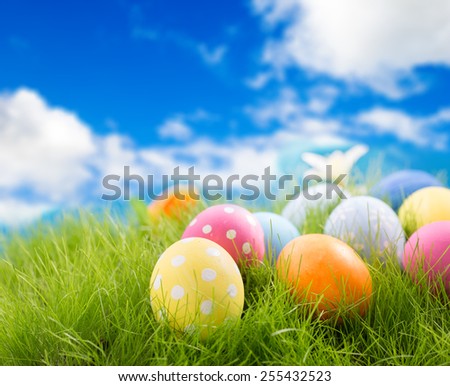 Decorated easter eggs in grass on sky background