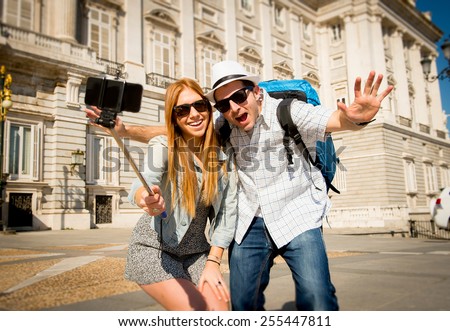 young beautiful friends tourist couple visiting Spain in holidays exchange students and taking selfie stick picture together in town happy on sunny day in travel and vacation concept Royalty-Free Stock Photo #255447811