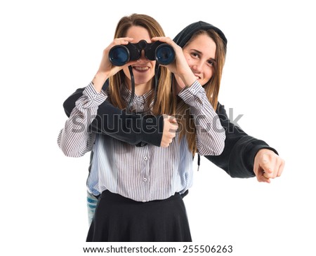 Twin sisters with binoculars
