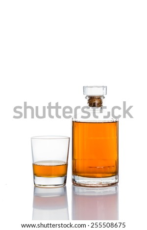 Whiskey on the rocks, with a whiskey bottle isolated in white