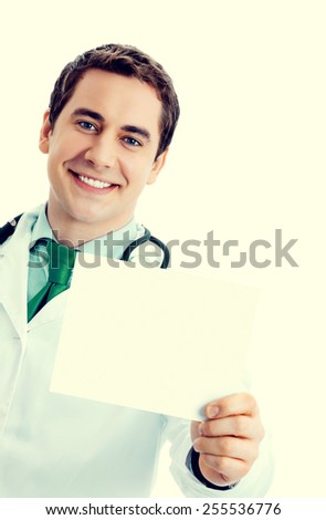 Portrait of cheerful doctor in green tie, with blank signboard with copyspace area for text or slogan
