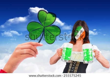 Irish girl with beer against bright blue sky with clouds