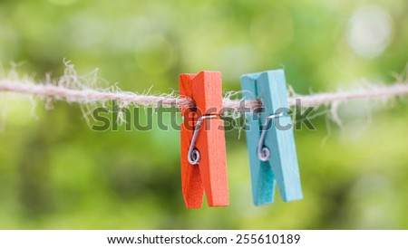 wooden clothespin hanging on rope, depth of field