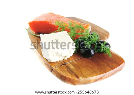 single pink salmon bit on a big wooden dish with white cheese