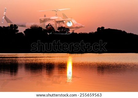 Double exposure of helicopter on sunset and river background
