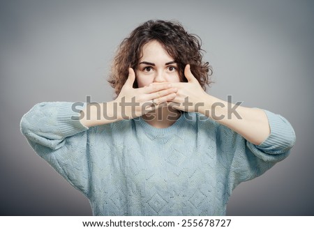 Woman shutting her mouth Royalty-Free Stock Photo #255678727