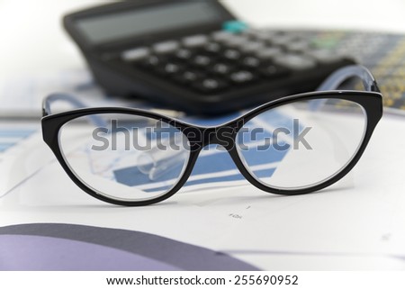 Photo of the Businessman analyzing investment charts with calculator and laptop