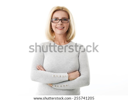 Portrait of mature business woman smile while standing against white background. 