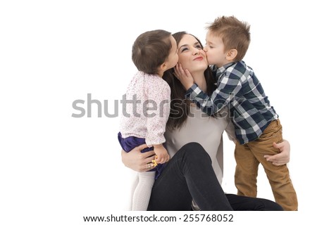 little girl and boy kissing their mother