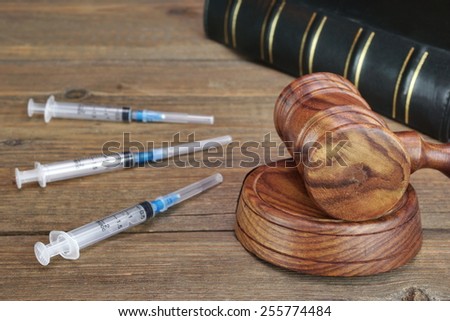 Judges Gavel,  Law Book,  Medical And Narcotic Drugs On Grunge Wood Table Royalty-Free Stock Photo #255774484