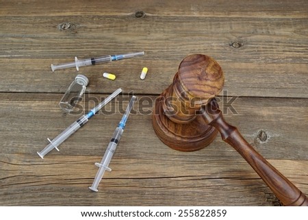 Judges Gavel And Medical Drugs On Grunge Wood Table Royalty-Free Stock Photo #255822859