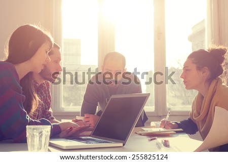 Young group of people/architects discussing business plans. Royalty-Free Stock Photo #255825124