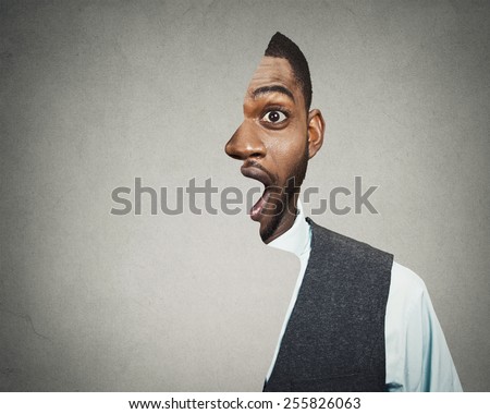 surrealistic portrait headshot front with cut out profile of a young astonished handsome man isolated grey wall background 