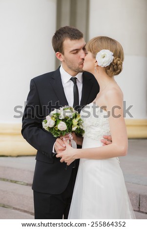 Elegant bride and groom posing together outdoors on a wedding day