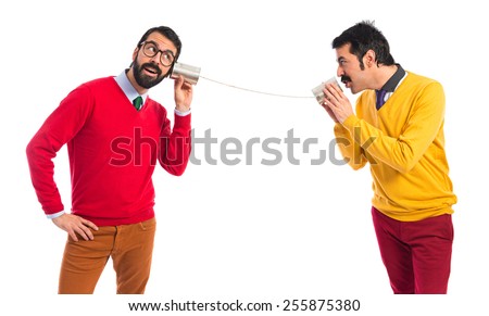 Twin brothers talking through a tin phone  Royalty-Free Stock Photo #255875380