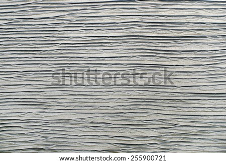 Silver textured background. Grey wavy pattern fabric.