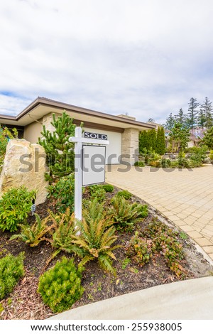 House For Sale. Real Estate Sign in Front of a House. Sold.
