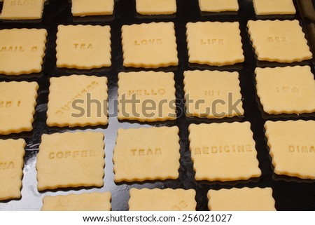 Making cookie with signs on baking tray