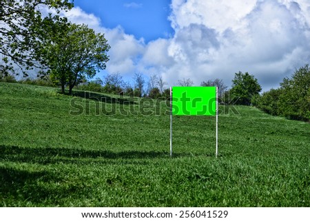 Big blank and green billboard in the nature. Copy space