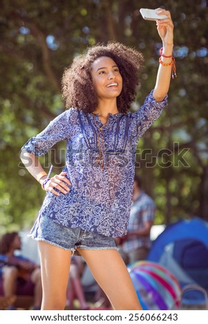 Pretty hipster taking a selfie at a music festival