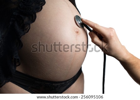belly of pregnant woman and stethoscope, isolated on white background