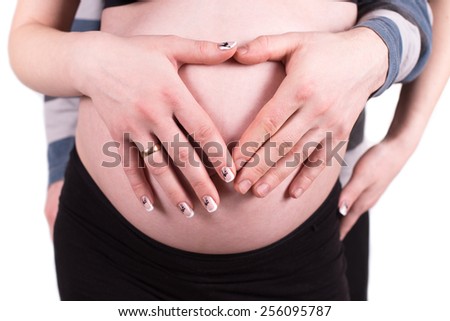 Heart shaped hands of pregnant woman and her husband, isolated on white background