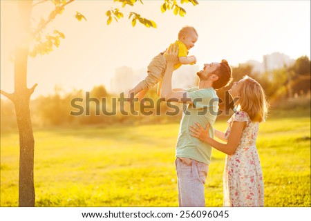 Happy family at sunset
