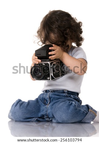 young child with old SLR camera