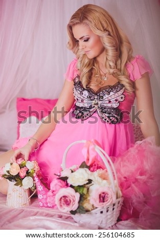 Portrait of beautiful young woman in pink fashion clothes